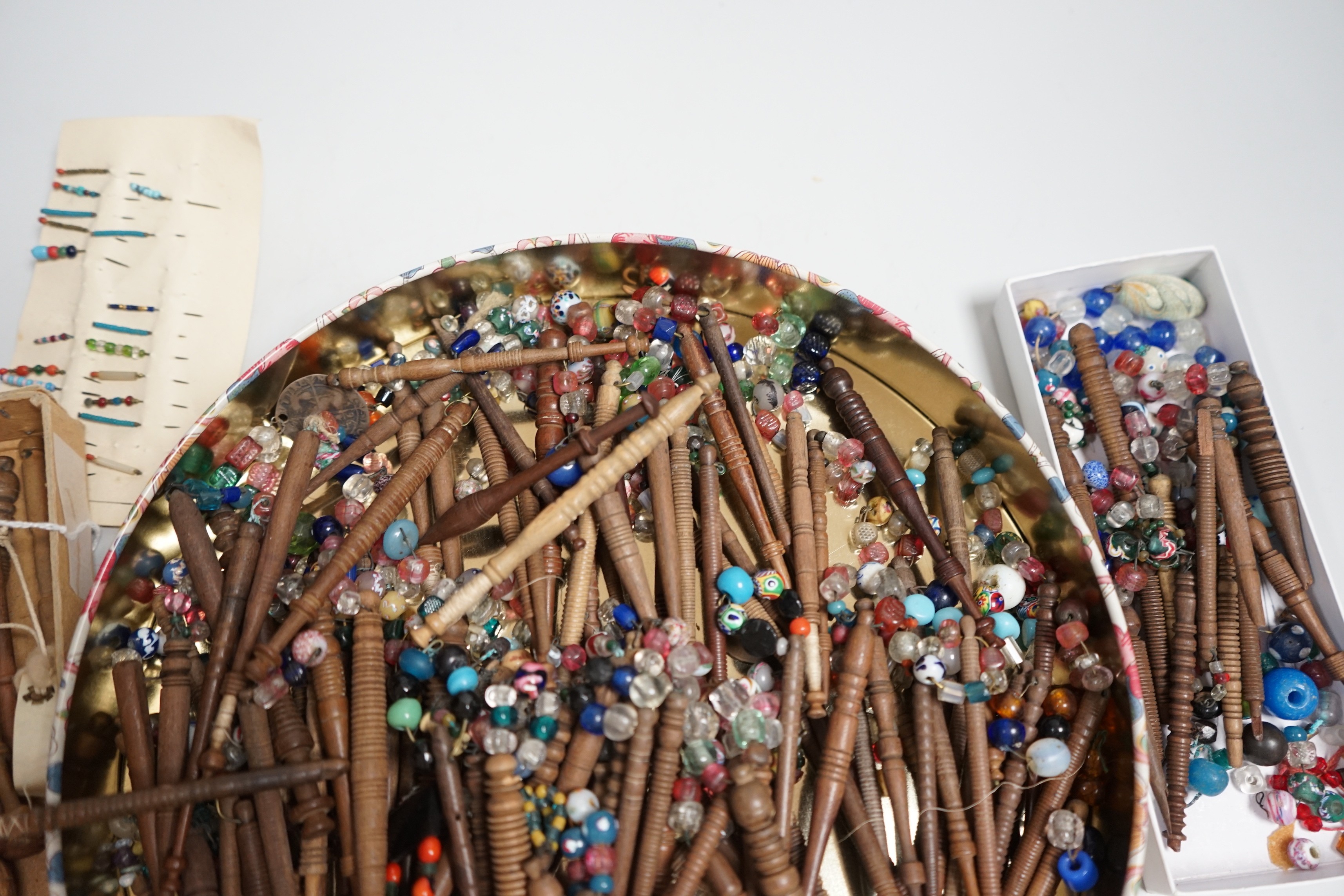 One hundred 19th century turned lace bobbins, plus various broken bobbins and spare beading